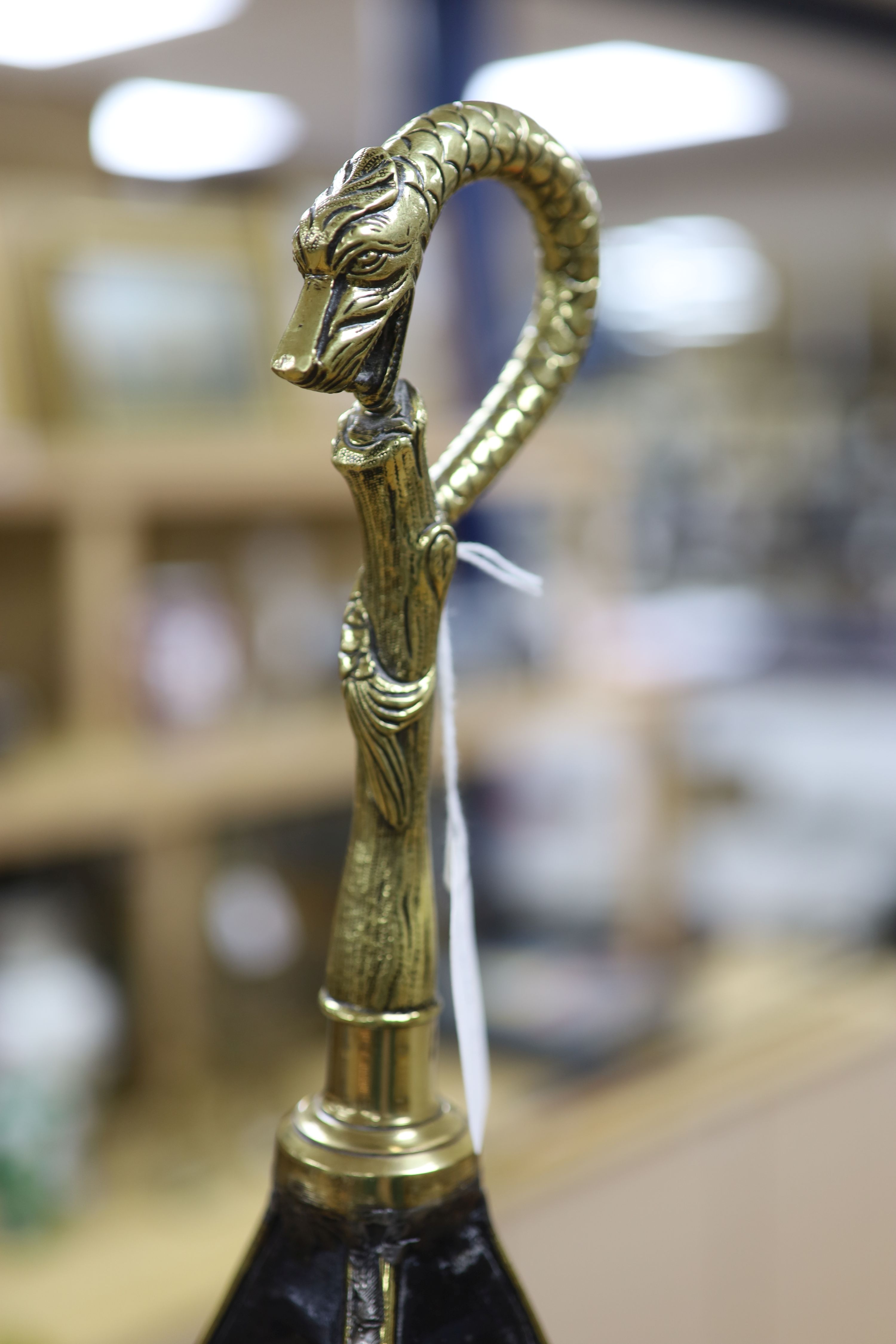 A Dutch brass embossed parasol shaped stick stand, height 91cm